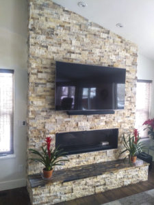 Stone Veneer with granite hearth a gas 56 inch fireplace